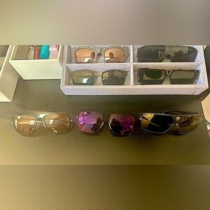 Two pairs of Versace and a single pair of Prada sunglasses, sold as a bundle.